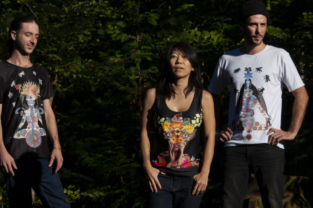 Three people wearing shirts printed with Fistook collages