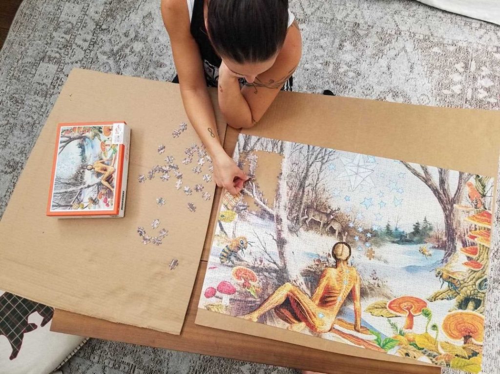 Putting together a collage puzzle on the floor